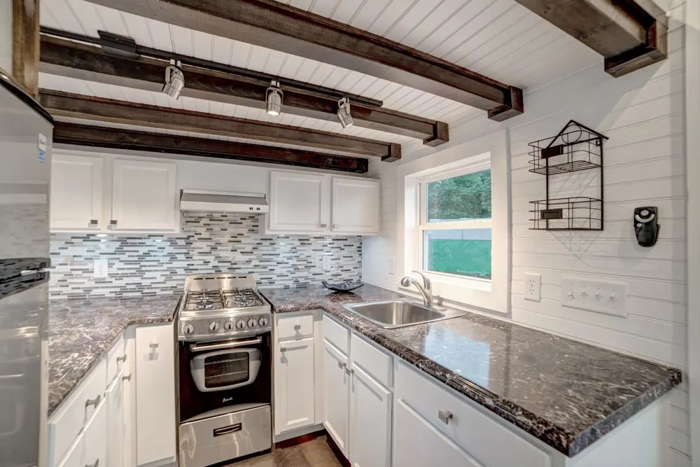 Kitchen with white cabinets - Freedom by Alabama Tiny Homes