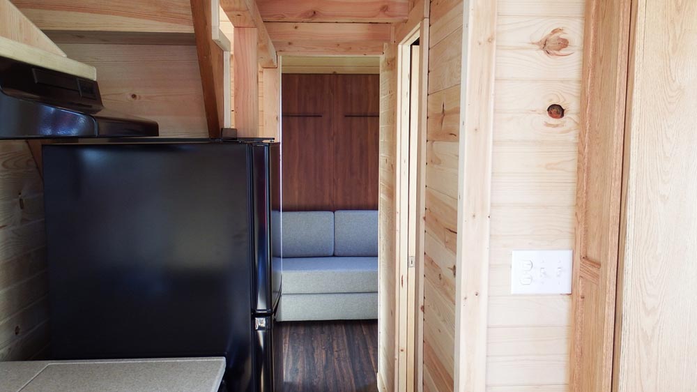 Refrigerator and bed/couch area - Murphy by Tiny Idahomes