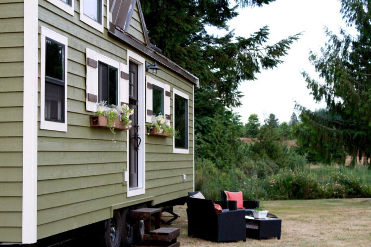 Green siding with white trim on this Vintage model by Tiny Heirloom