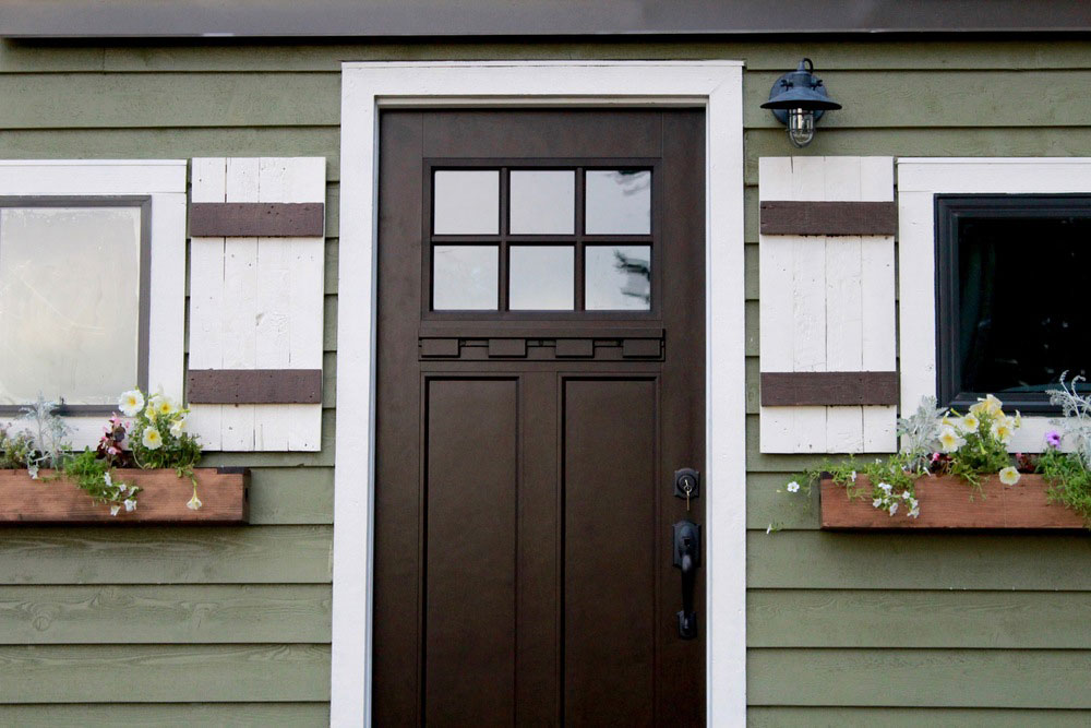 Dark door contrasts nicely with the siding and trim - Vintage by Tiny Heirloom