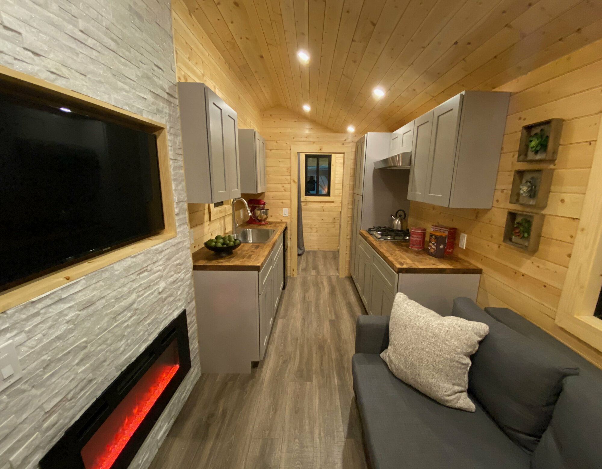 Living Room w/ Fireplace - Flat by Uncharted Tiny Homes