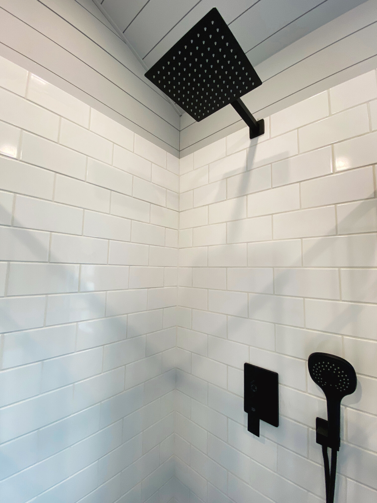 White Tile Shower - Lauren's Flat by Uncharted Tiny Homes