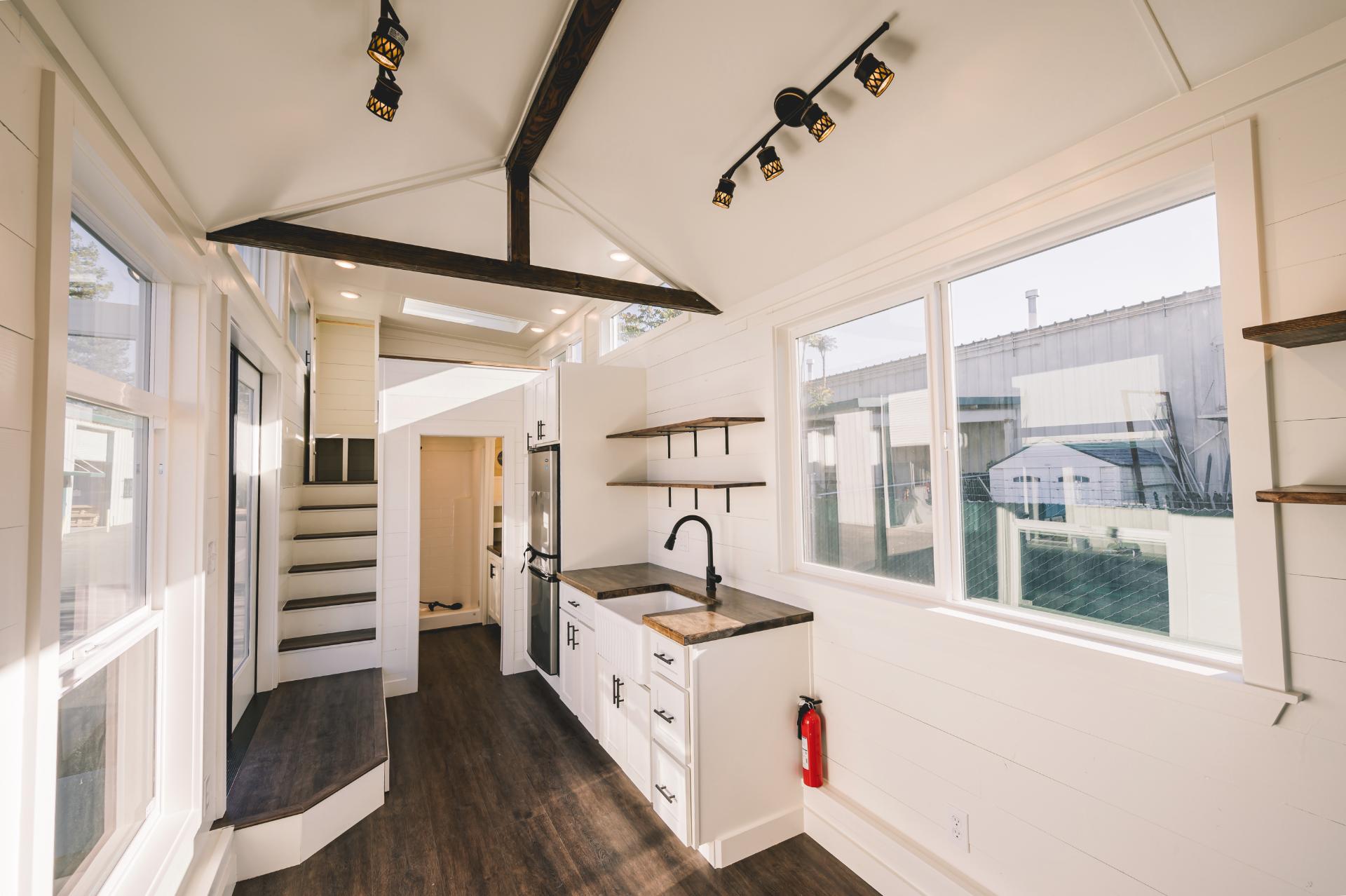 White Walls and Ceilings with Dark Stained Floors and Open Beams - Gallery 30 by California Tiny House