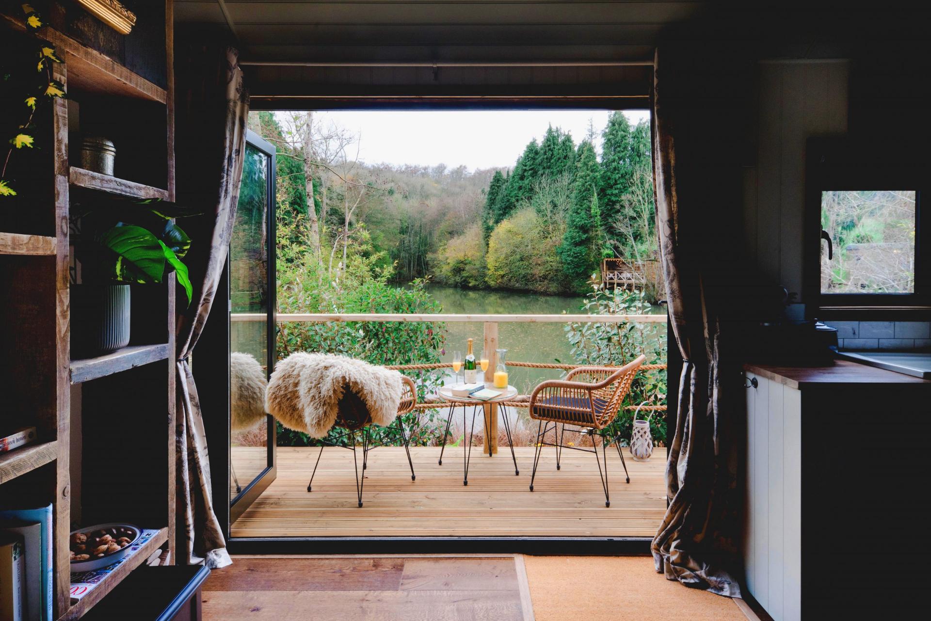 View From Tiny House onto Patio with Two Chairs and a Table - Hut 1898 at The Shepherds Hut Retreat