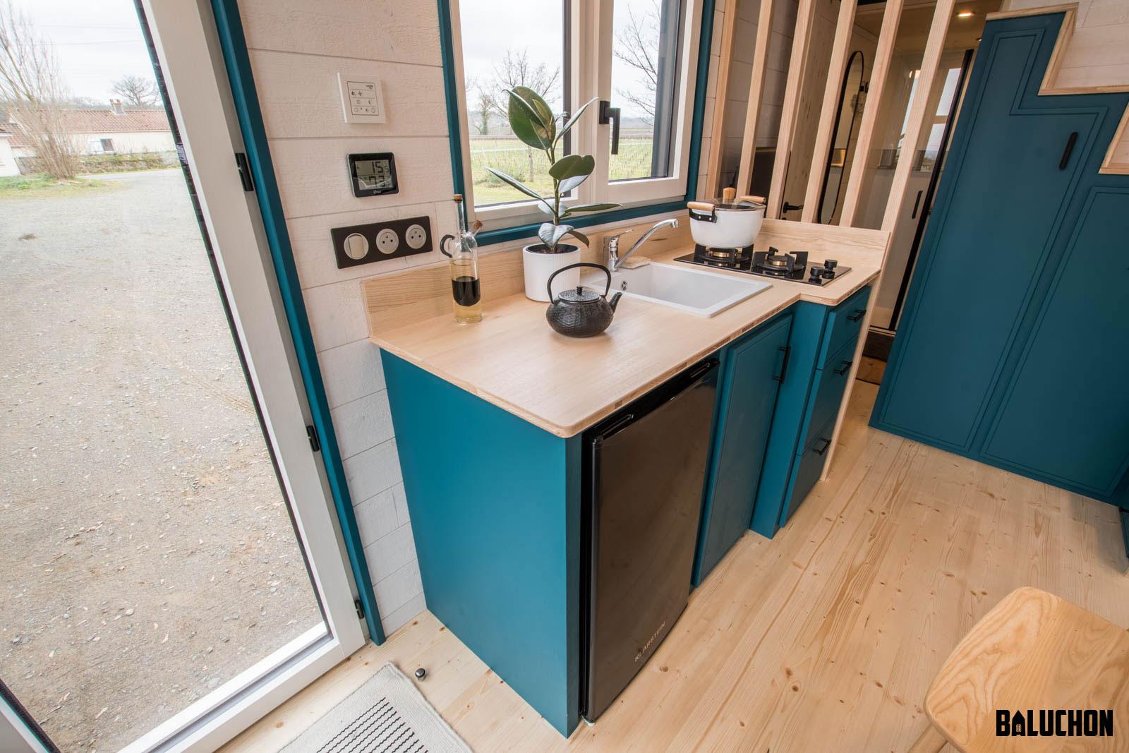 Wood Countertop and Teal Cabinets in Kitchen - Sherpa by Baluchon
