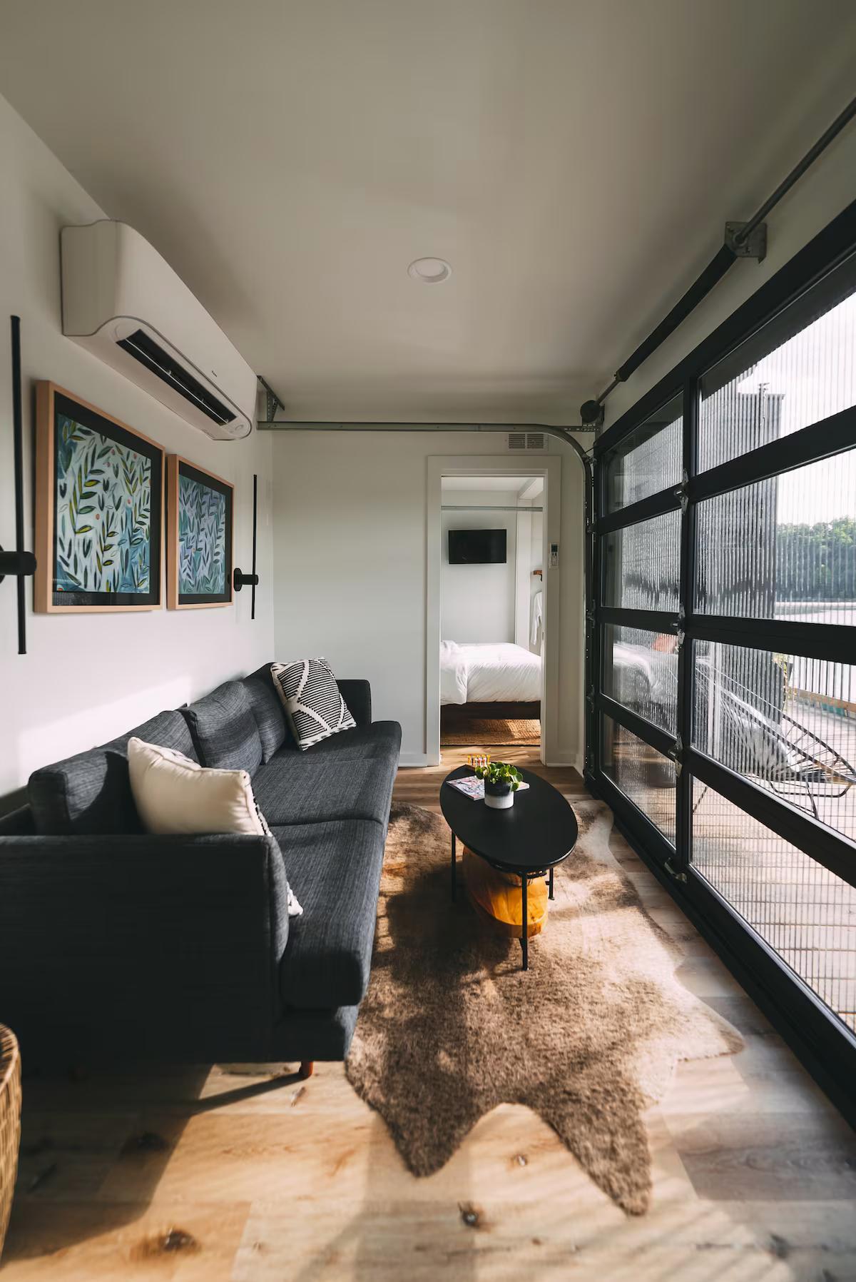 Living Room with Garage Door Rolled Down - The Hive at Addison Farms