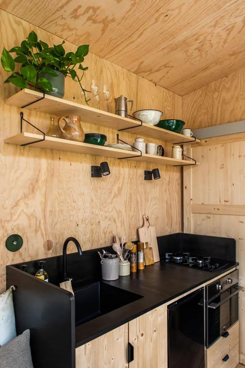 Kitchen with Black Countertop - Atelier Du Mas by Plume Habitat