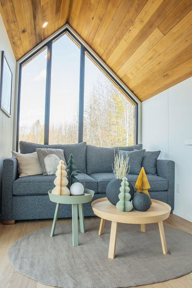 Living Room with Large Window and Full Couch - Halcyon Lux by Fritz Tiny Homes