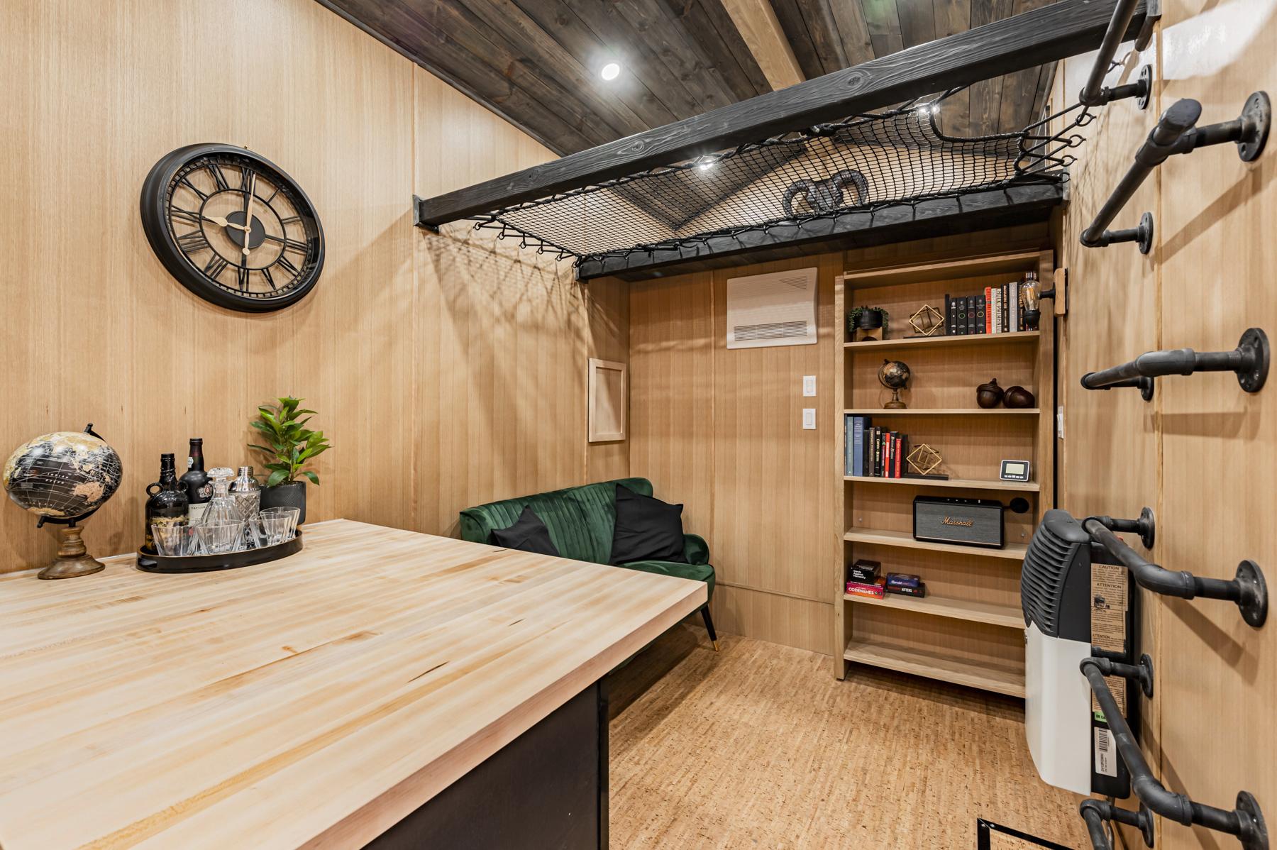 Living Area with Bookcase - Sherloak Homes by Acorn Tiny Homes