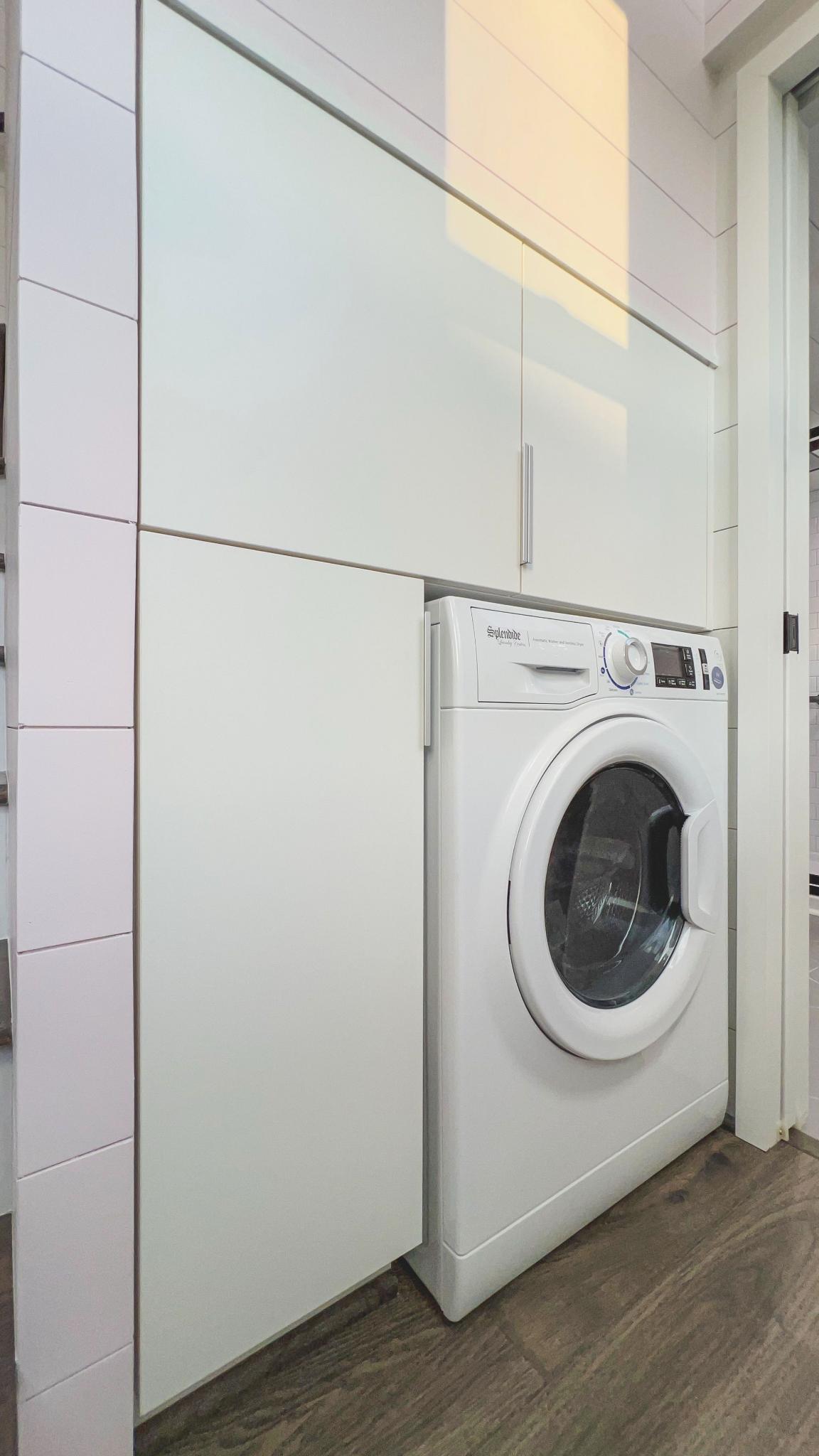 Laundry Area with Storage and Washer/Dryer - Kupersmit Tiny House by Movable Roots