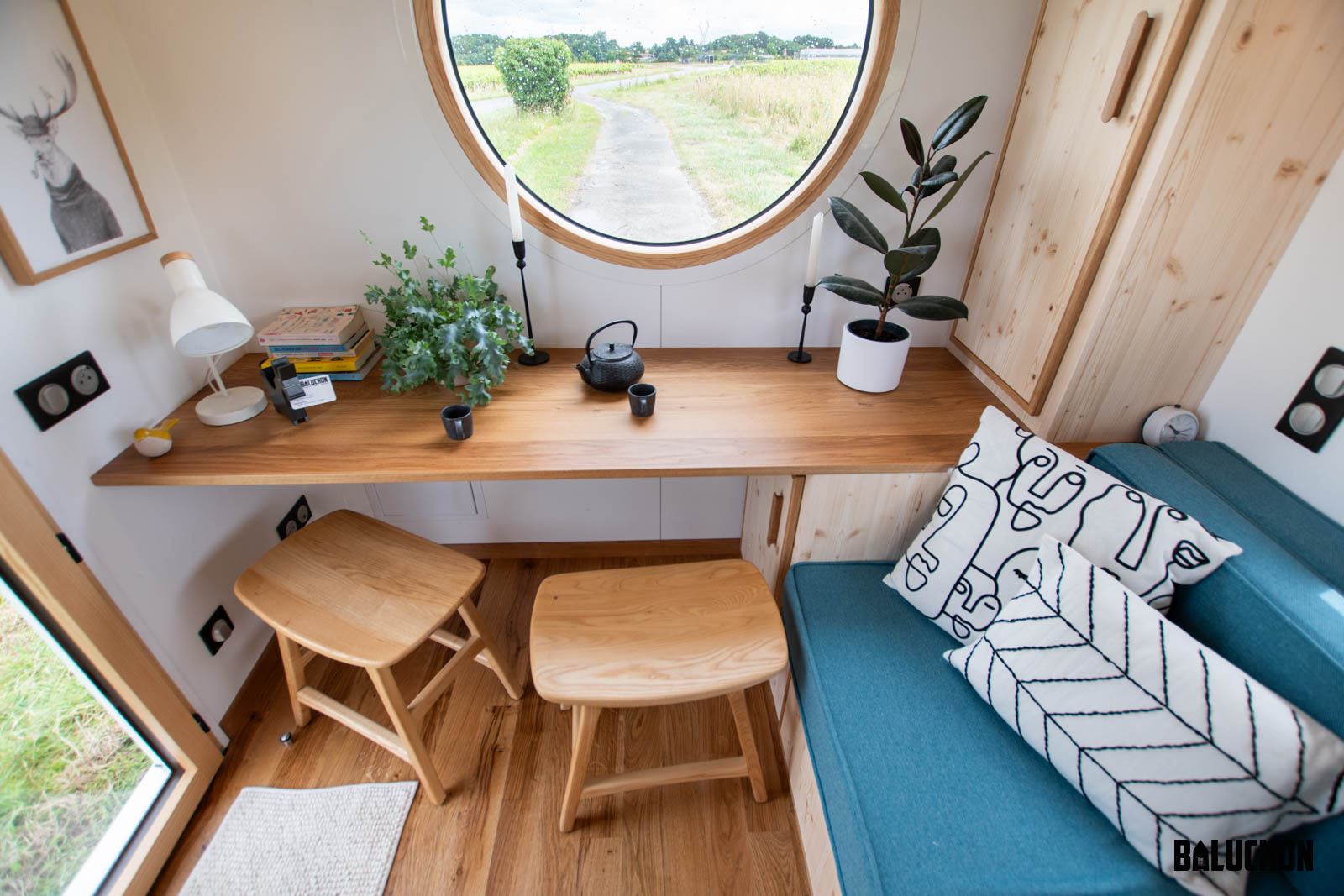 Desk in Front of Circular Window - Nano Suisse by Baluchon