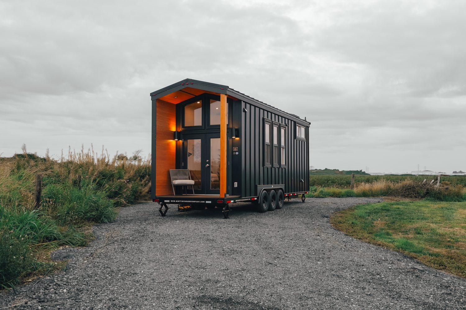 Black Exterior with Wood Accent Around 4' Outdoor Deck - Onyx 2630 by Mint Tiny House Company