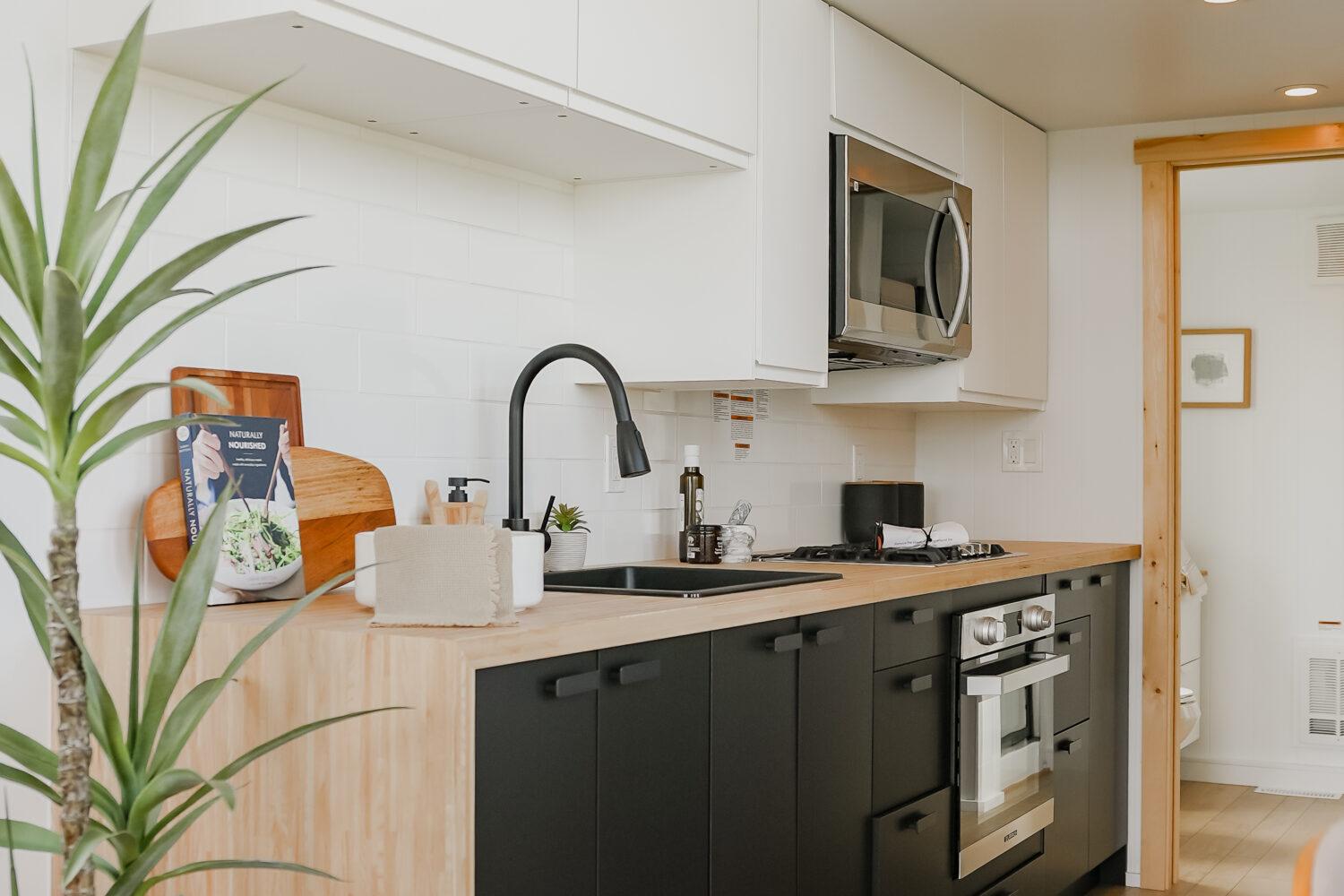 Kitchen with Black Cabinets - Onyx 2630 by Mint Tiny House Company