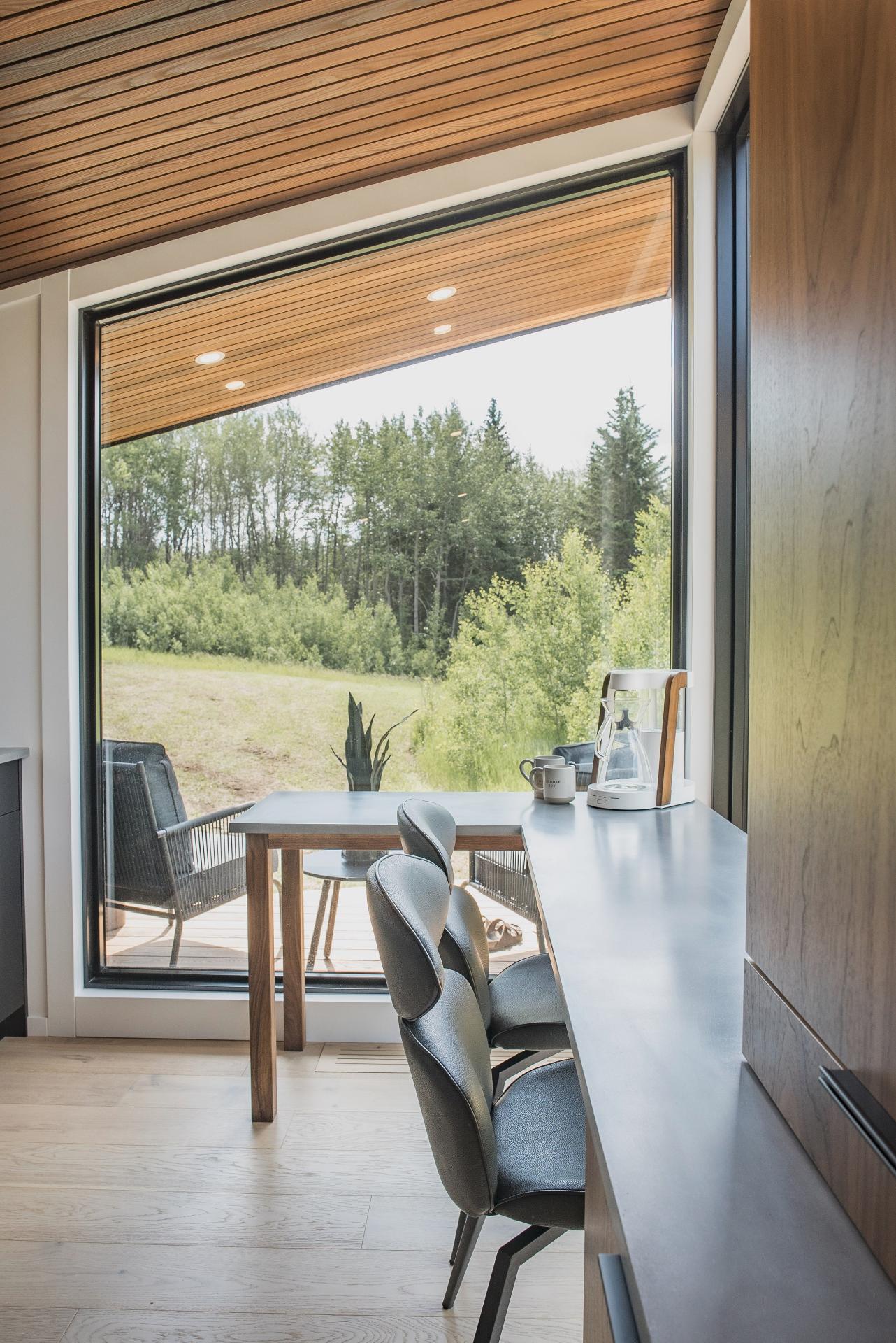 Table with Chairs in Front of Picture Window - Refuge Bay Halcyon Stay by Fritz Tiny Homes