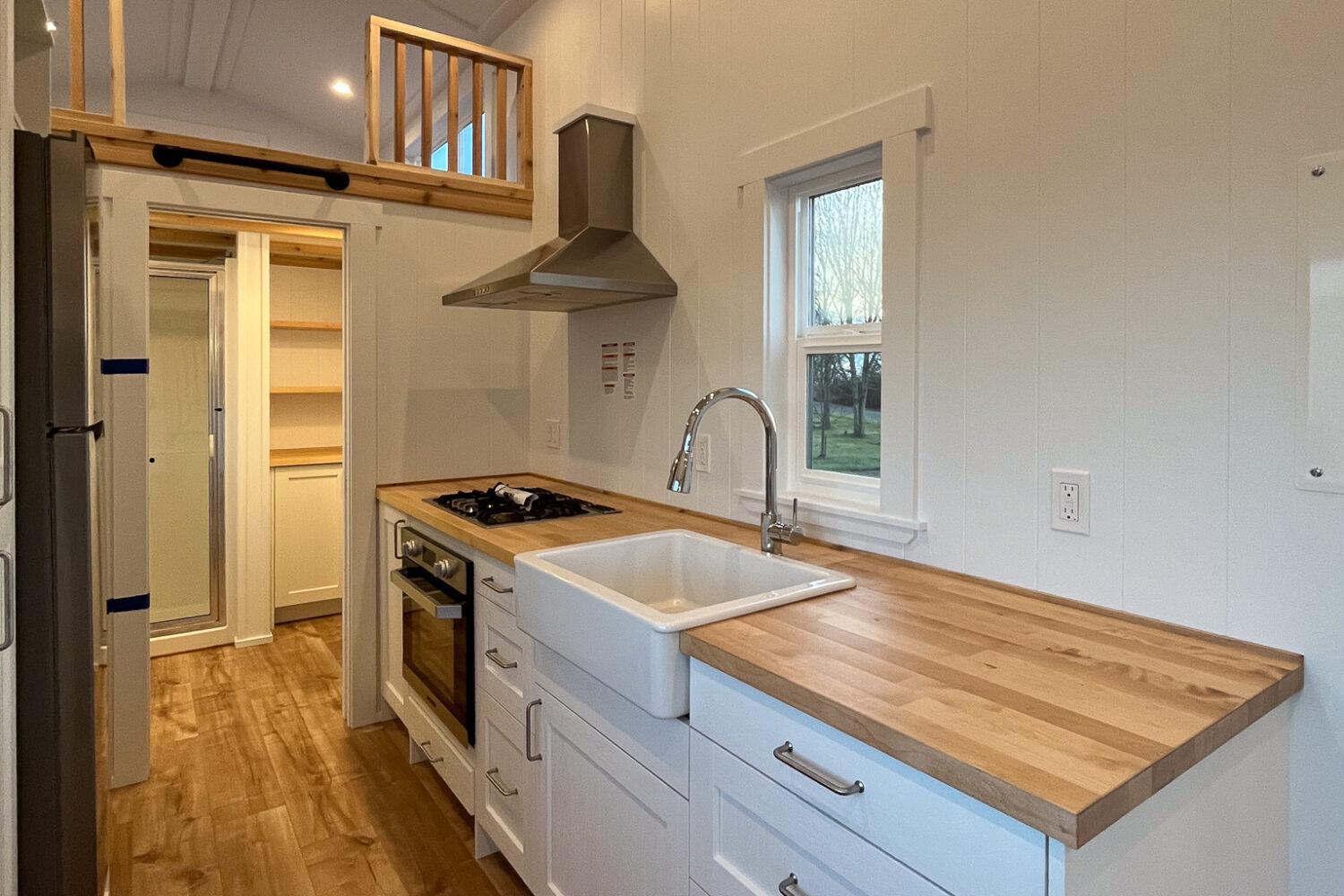 Kitchen with White Farm Sink - Loft Ruby Edition by Mint Tiny House Company